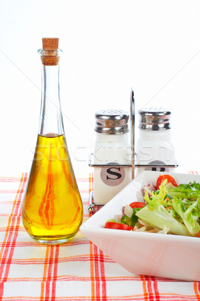 Oil bottle, green salad, salt and pepper Stock photo © broker