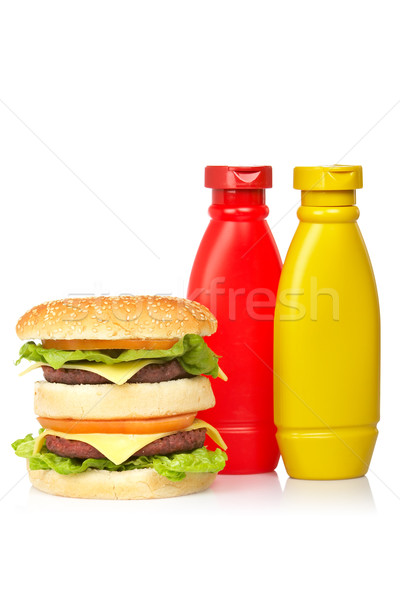 Verdubbelen cheeseburger mosterd ketchup flessen witte Stockfoto © broker