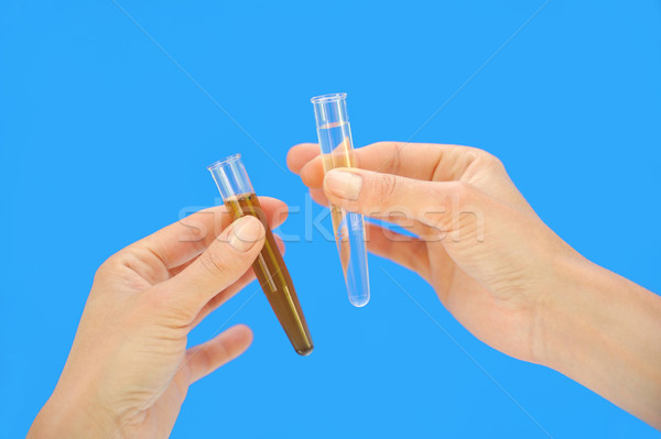 Clean and dirty water samples in hands Stock photo © brozova