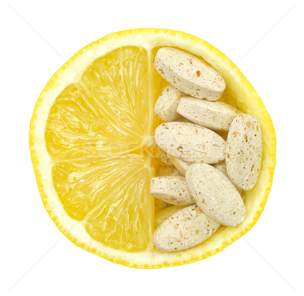 Close up of lemon and pills isolated – vitamin concept - vitamin c Stock photo © brozova