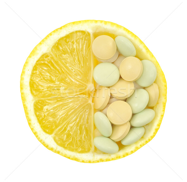 Stock photo: Close up of lemon and pills isolated – vitamin concept - vitamin c