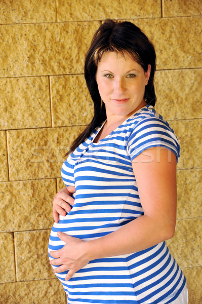 Young pregnant woman standing Stock photo © brozova