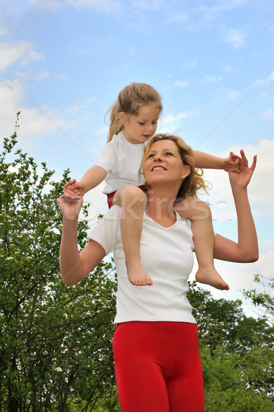 Young woman carrying her daughter over the shoulders Stock photo © brozova