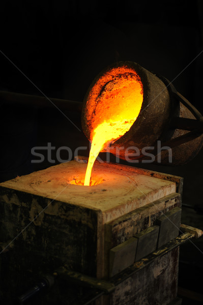 Foundry - molten metal poured from ladle into mould - lost wax casting Stock photo © brozova