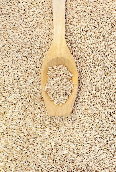 Wooden spoon and dried husked oats Stock photo © brozova