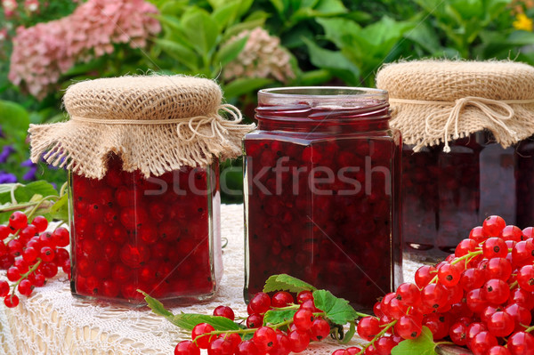 Stock photo: Jars of homemade red currant jam with fresh fruits