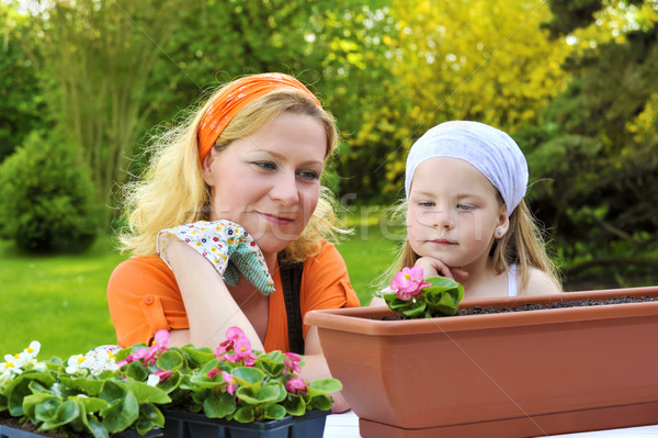 Stock photo: Young mother and her daughter having gardening time