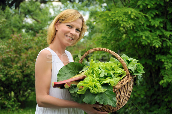 Young woman holding basket with vegetable Stock photo © brozova