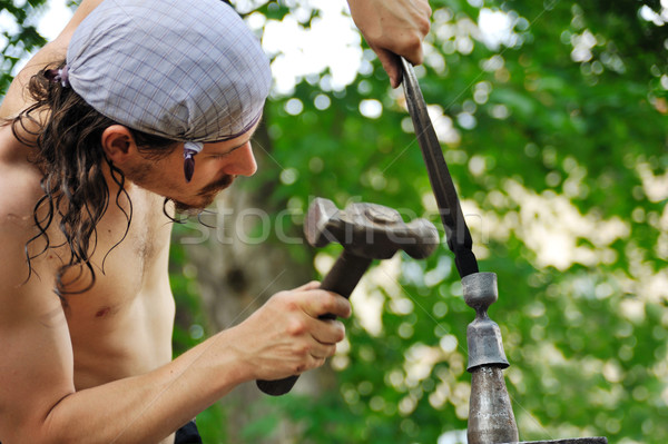 Genç demirci sıcak demir örs eller Stok fotoğraf © brozova