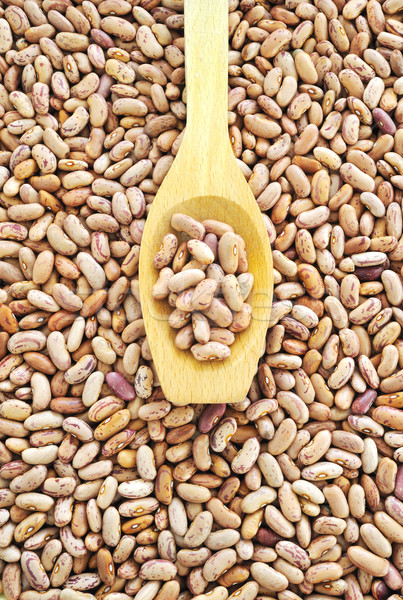 Wooden spoon and dried pinto beans Stock photo © brozova