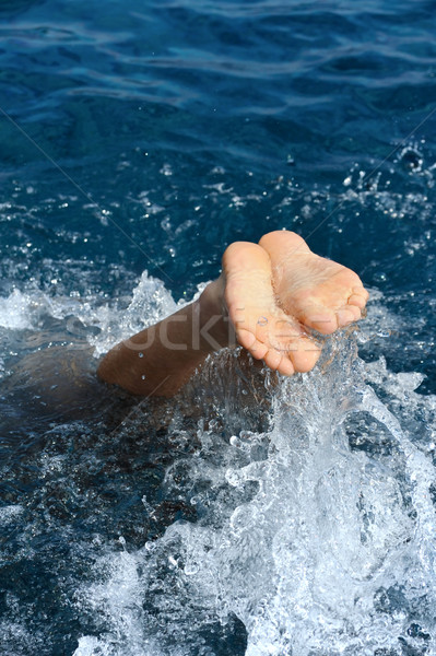 Young man jumping into water Stock photo © brozova