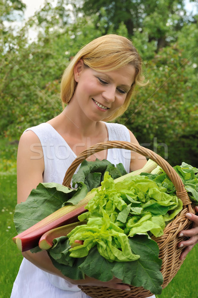 Young woman holding basket with vegetable Stock photo © brozova