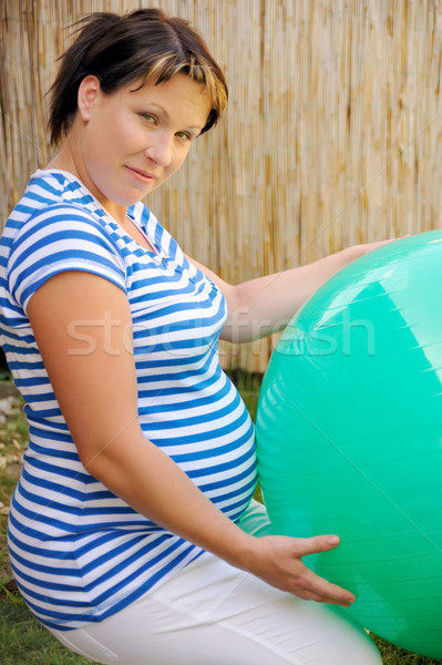 Pregnant young woman exercising with ball Stock photo © brozova