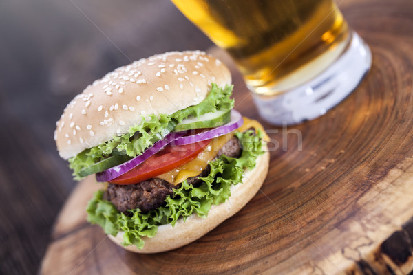 Beef burgers on a wooden board with aromatic spices Stock photo © BrunoWeltmann