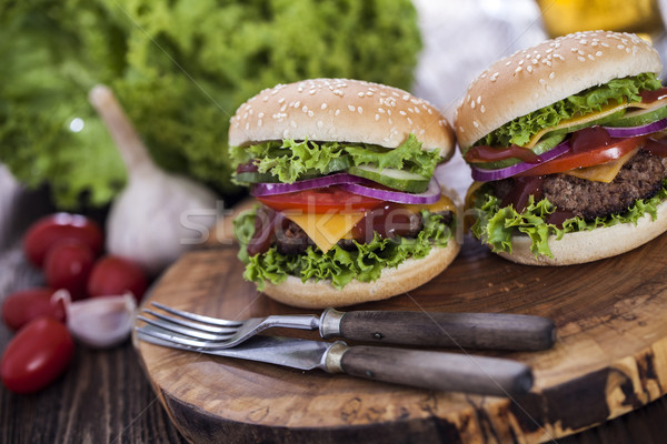 Beef burgers on a wooden board with aromatic spices Stock photo © BrunoWeltmann