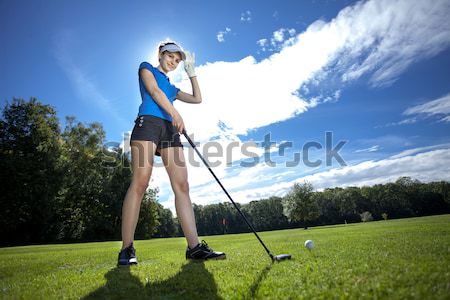 Pretty girl playing golf on grass Stock photo © BrunoWeltmann