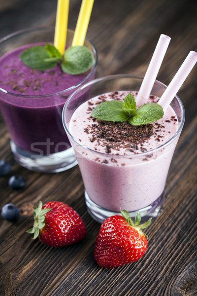 Stock photo: Tasty strawberry and blueberry shake on wooden table!