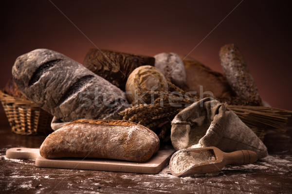 Fresh bread and wheat on the wooden table Stock photo © BrunoWeltmann