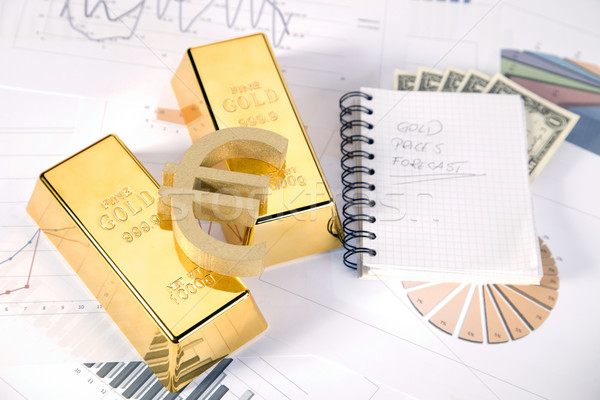 Stock photo: Gold bars on graphs and statistics