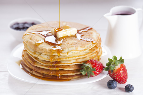 Delicious sweet American pancakes on a plate with fresh fruits Stock photo © BrunoWeltmann