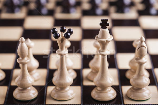 Stock photo: Chess pieces on a chessboard.