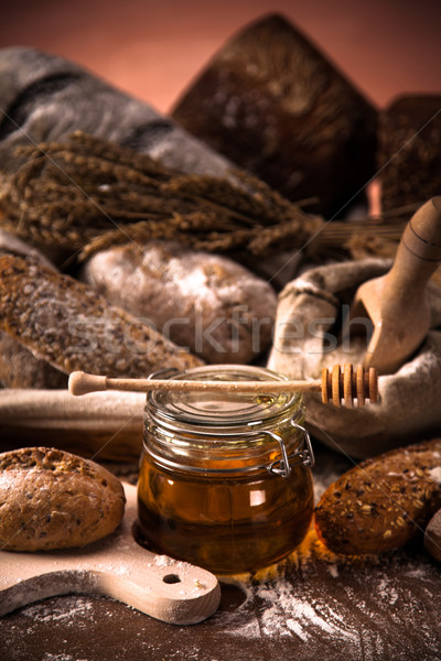 Fresh bread and wheat on the wooden table Stock photo © BrunoWeltmann