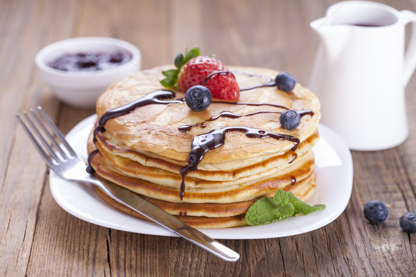 Delicious sweet American pancakes on a plate with fresh fruits Stock photo © BrunoWeltmann