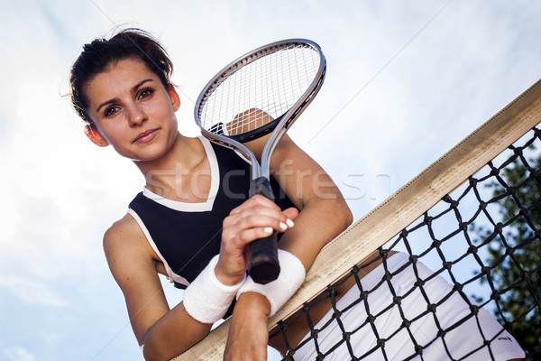 Beautiful young girl rests on a tennis net Stock photo © BrunoWeltmann