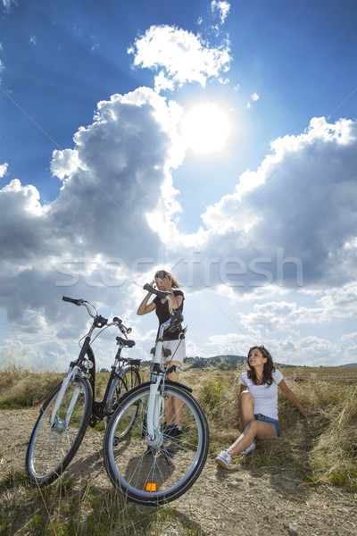 Two pretty girls on bike tour Stock photo © BrunoWeltmann