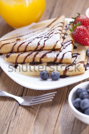 Delicious sweet French pancakes on a plate with fresh fruits Stock photo © BrunoWeltmann