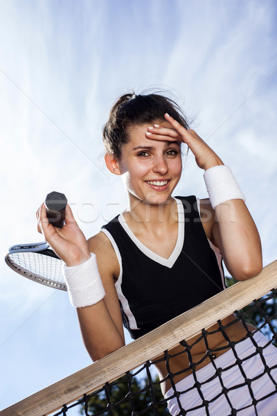 Stock photo: Beautiful young girl rests on a tennis net