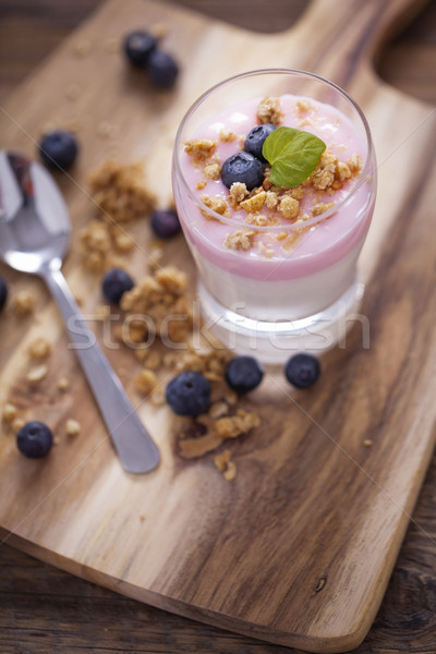Delicious dessert, flakes flooded in two flavors yogurt with blu Stock photo © BrunoWeltmann