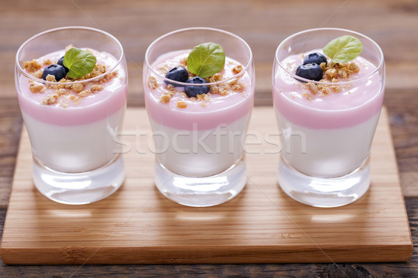 Stock photo: Delicious dessert, flakes flooded in two flavors yogurt with blu