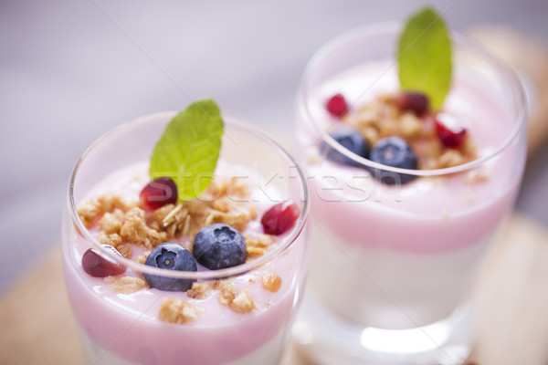 Stock photo: Delicious dessert, flakes flooded in two flavors yogurt with blu
