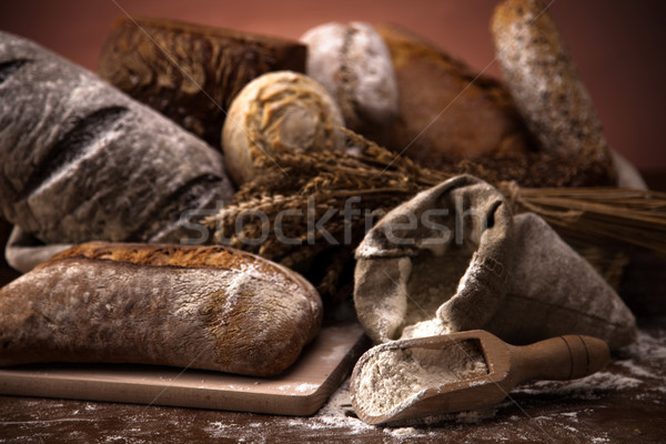 Fresh bread and wheat on the wooden table Stock photo © BrunoWeltmann