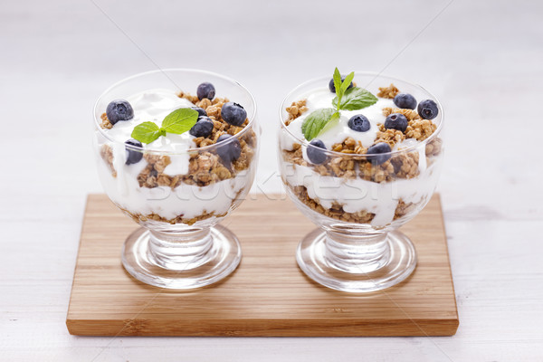 Delicious dessert, flakes flooded in two flavors yogurt with blu Stock photo © BrunoWeltmann