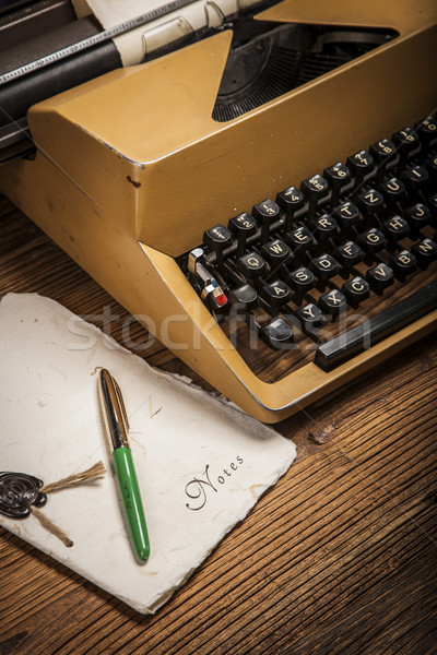 Stock photo: old typewriter, a pile of books and a lot of creativity