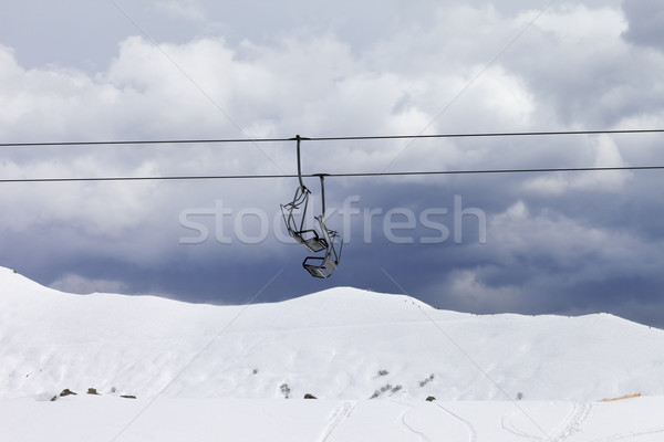 Stock photo: Chair lifts and off-piste slope at gray day