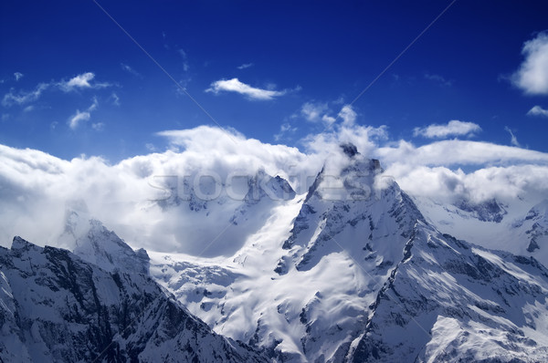 Snowy mountains in sunlight clouds Stock photo © BSANI