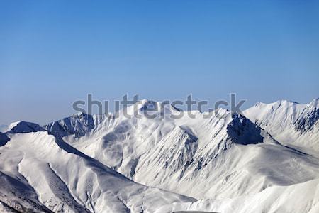 Winter snowy mountains with avalanche slope at evening Stock photo © BSANI