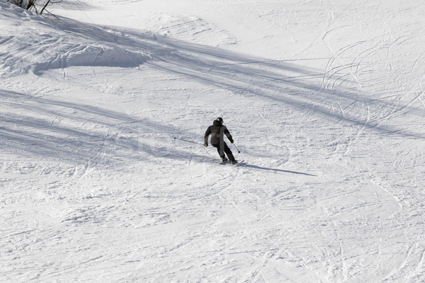 Skier on ski slope at sun winter day Stock photo © BSANI