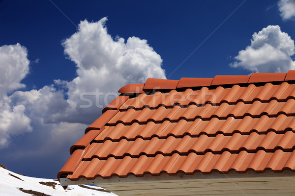 Roof tiles and blue sky with clouds Stock photo © BSANI