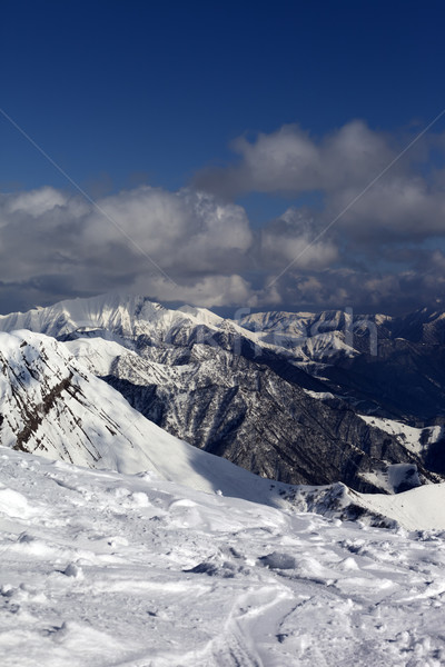 Sunlit mountains in clouds, view from off-piste slope Stock photo © BSANI