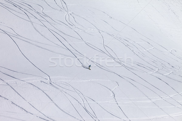 Snowboarder downhill on off piste slope with newly-fallen snow Stock photo © BSANI
