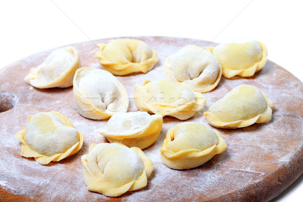 Raw homemade ravioli on wooden cutting board Stock photo © BSANI