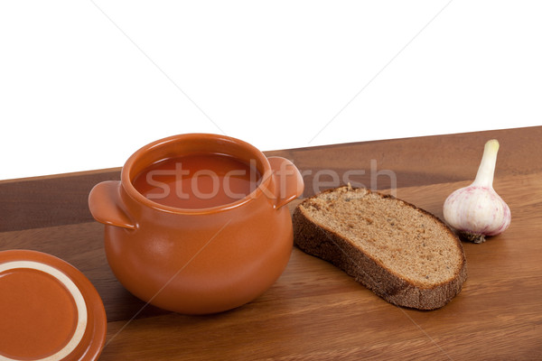 Soup in clay pot on wooden table Stock photo © BSANI