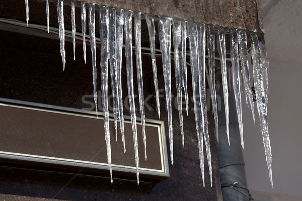Roof of house with icicles Stock photo © BSANI