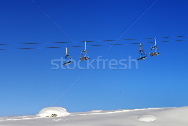 Chair-lift and blue clear sky at sunny day Stock photo © BSANI