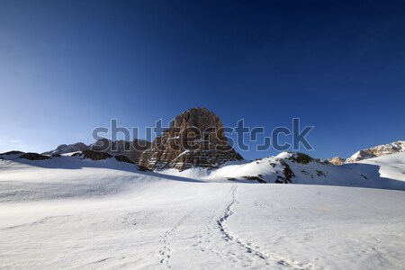 Snowy plateau and footpath against rock and blue sky in nice day Stock photo © BSANI