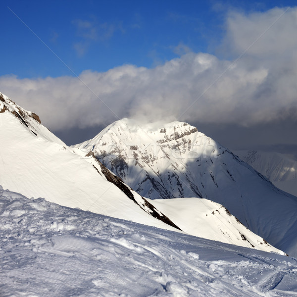 Off-piste slope and sunlit mountains at evening Stock photo © BSANI